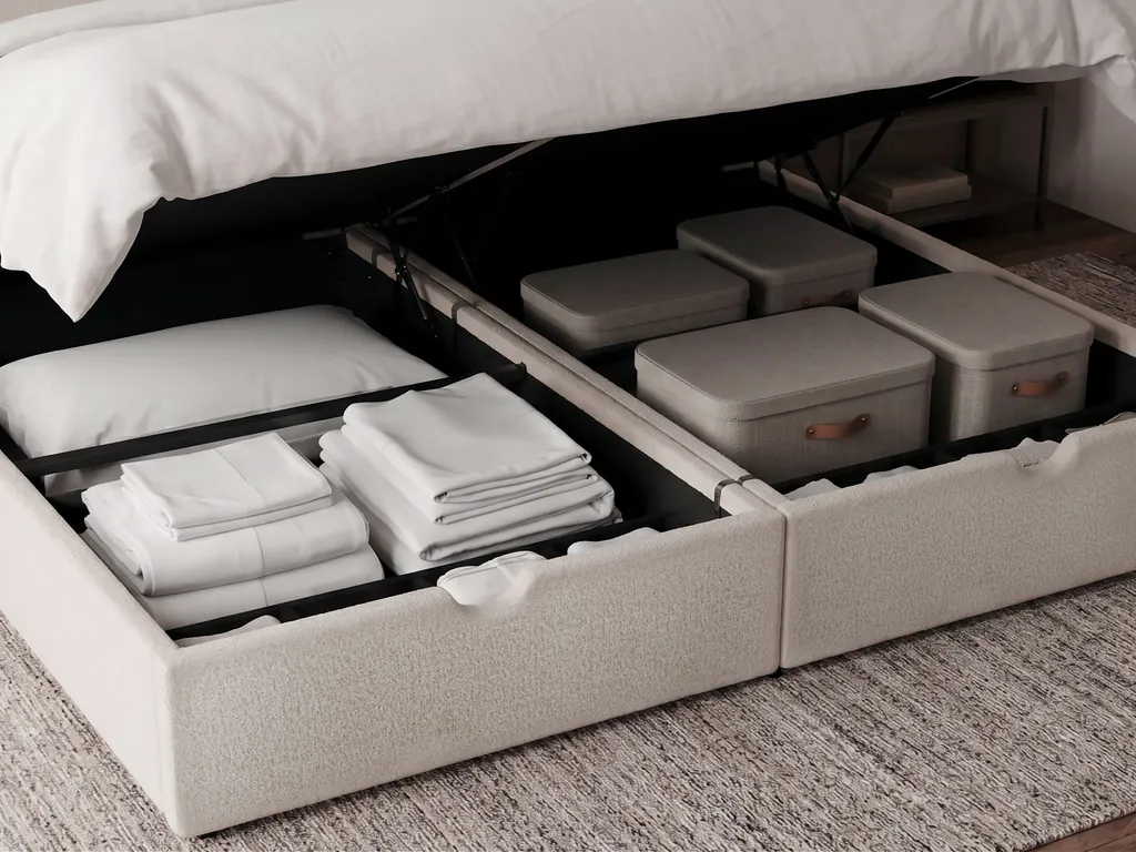 Coffre ouvert sous le couchage, avec le linge et des boîtes rangés